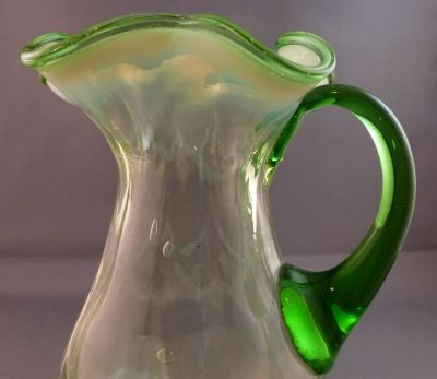 Opalescent drape and rib creamer/milk jug
Vertical ribs with opalescent drape. 
Keywords: table;blown;british