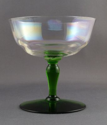 Iridescent, uranium-stem champagne coupe
Optic ribbing. ground rim. 1950s? Also suitable as a dessert dish
Keywords: barware;blown;sold