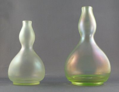 Fritz Heckert "cypern-glas" gourd vase
Little and large. Stretch iridescent finish on uranium glass. c. 1900. Made by Josephinenhutte.  (Thanks M) 5 and 6 in.
Keywords: czech;blown;vase
