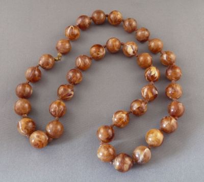 Celluloid "amber"
Vintage. Knotted
